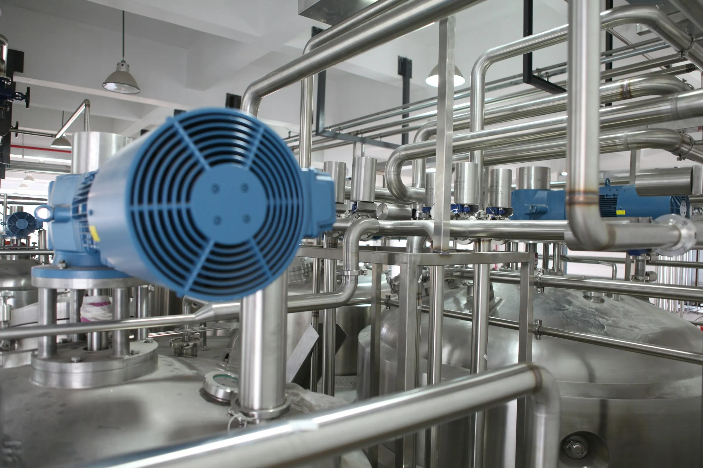 Photograph: a stainless-steel process plant with pipework, actuated valves and motors.